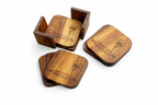 Set of wooden coasters with engraved design on a white background