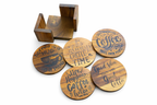 Set of wooden coasters with engraved text and a wooden holder on a white background
